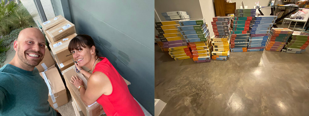 Stacks of finished jigsaw puzzle boxes on a floor